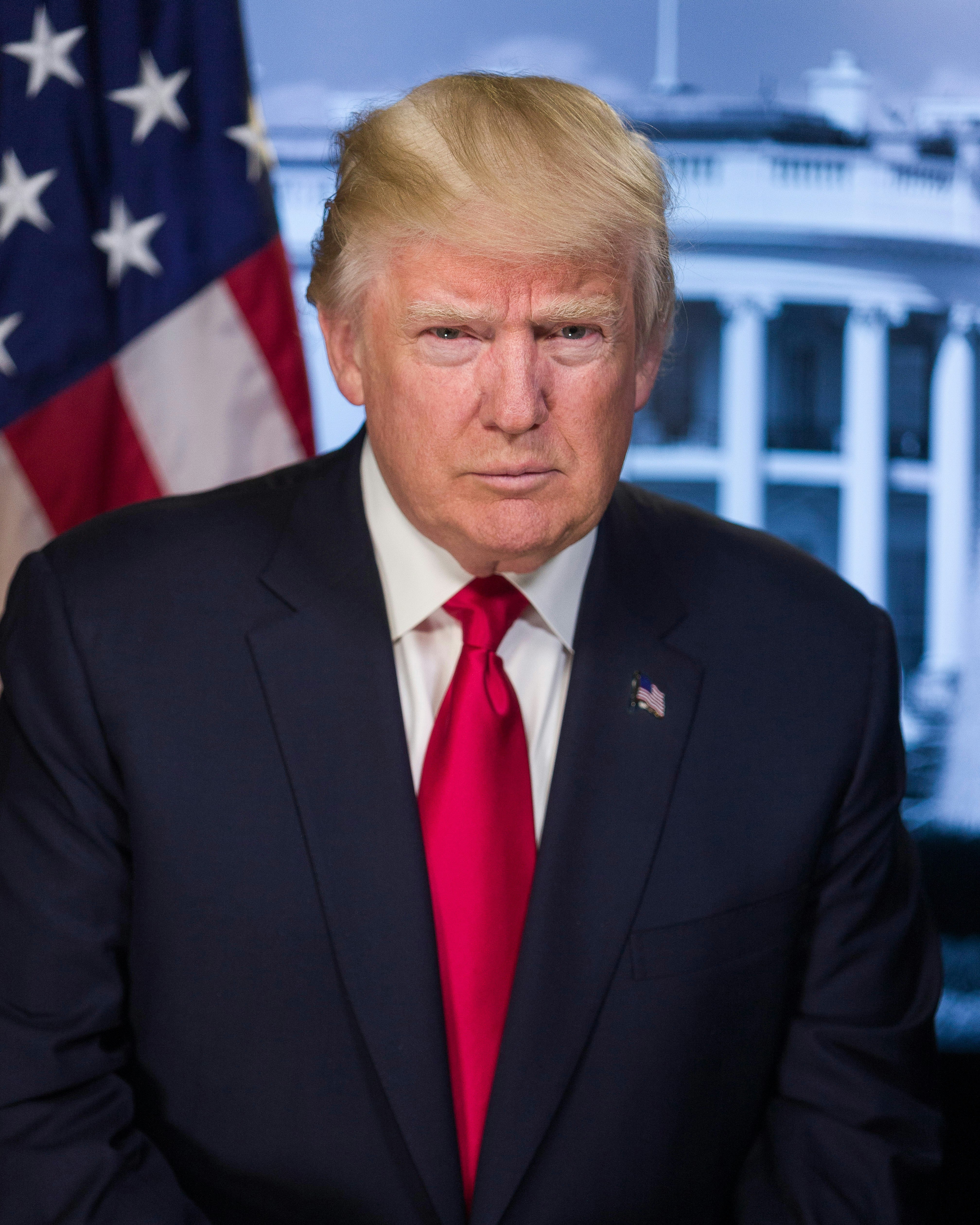 Portrét muže v obleku s červenou kravatou, stojící před americkou vlajkou a Bílým domem. Jedná se o Donalda Trumpa.